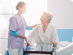Nurse assists a smiling elderly woman with a walker in a bright, modern healthcare environment.