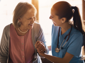 A nurse in blue scrubs engages warmly with an elderly woman, fostering a caring connection in a bright, inviting setting.